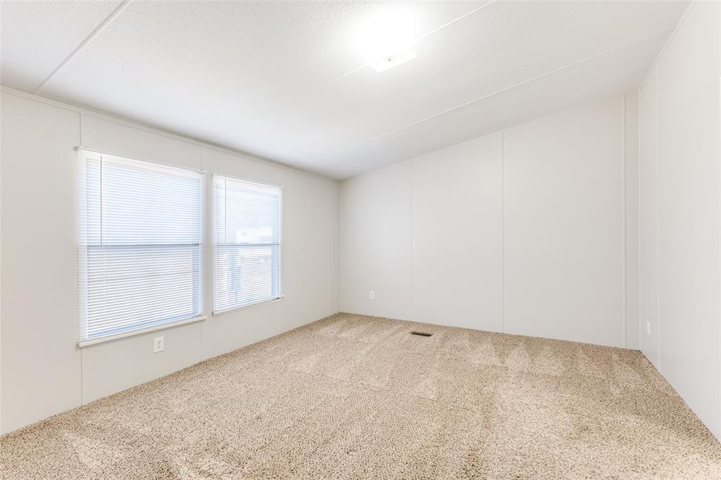 445 Arvel Circle Azle, TX 76020 - Photo 16 of 25 an empty room with wooden floor and windows