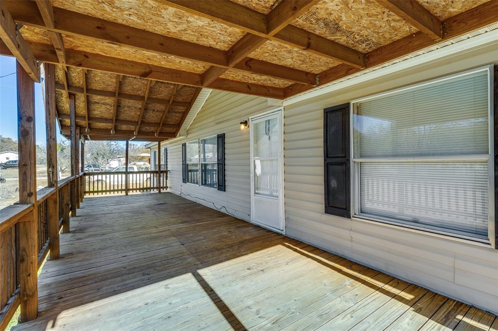 445 Arvel Circle Azle, TX 76020 - Photo 21 of 25 a view of porch with wooden floor and floor to ceiling window with wooden floor