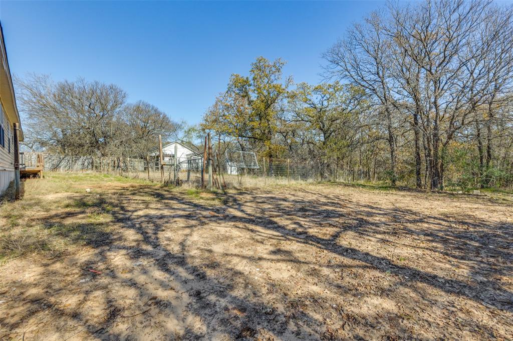 445 Arvel Circle Azle, TX 76020 - Photo 24 of 25 a view of dirt yard with a large tree