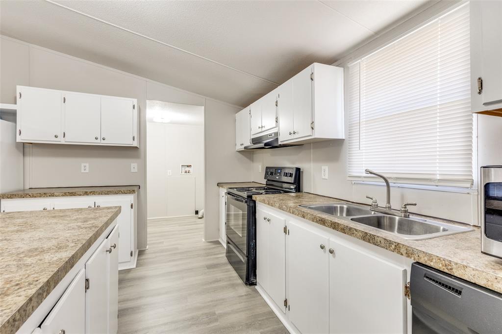 445 Arvel Circle Azle, TX 76020 - Photo 9 of 25 a kitchen with stainless steel appliances granite countertop a sink stove and refrigerator