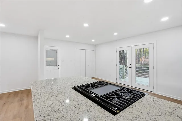 a living room with hard wood floor and a rug