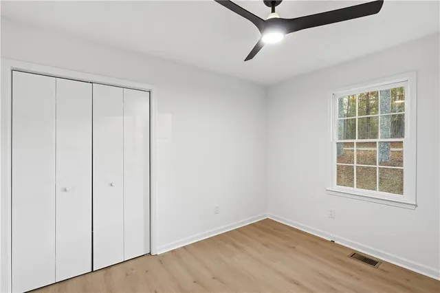 an empty room with windows and closet