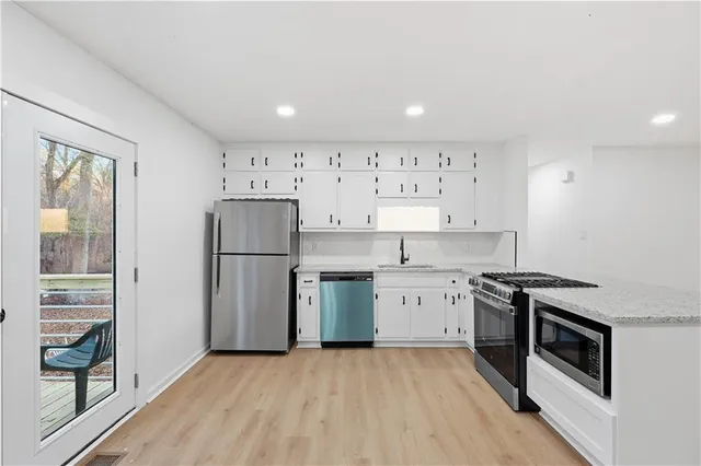 a kitchen with a sink a stove and refrigerator
