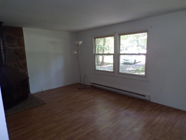101 Mohawk Trail Albrightsville, PA 18210 - Photo 12 of 16 an empty room with wooden floor and windows