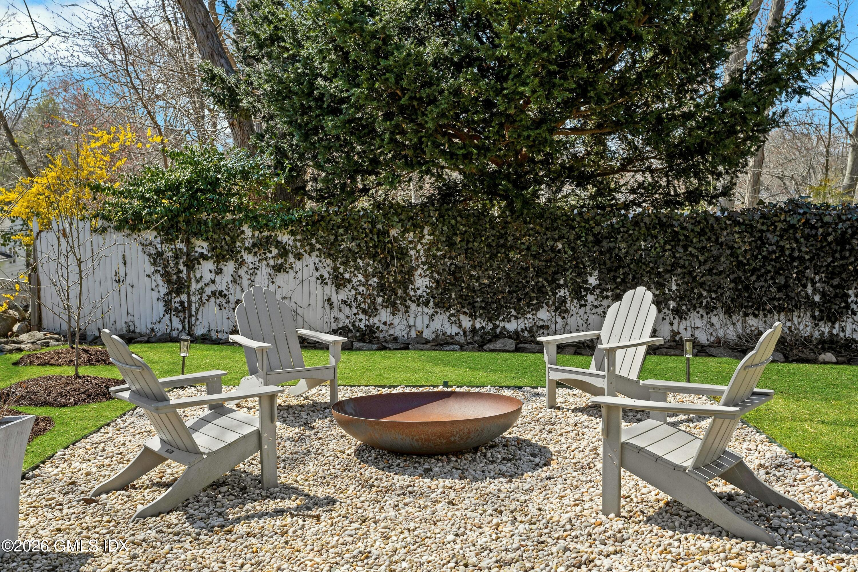 16 Summit Road Riverside, CT 06878 - Photo 29 of 34 a view of a backyard with table and chairs potted plants and large tree