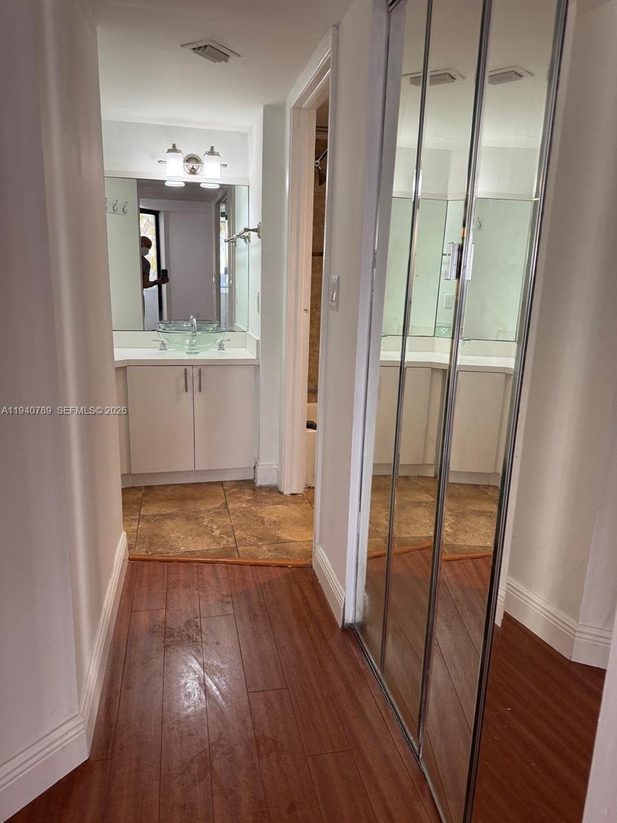 8335 Southwest 152nd Avenue, Unit B309 Miami, FL 33193 - Photo 21 of 26 a view of a hallway with wooden floor and staircase