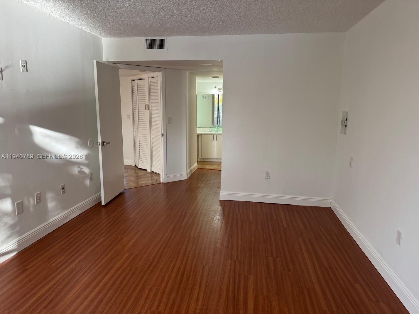 8335 Southwest 152nd Avenue, Unit B309 Miami, FL 33193 - Photo 23 of 26 a view of a room with wooden floor and window