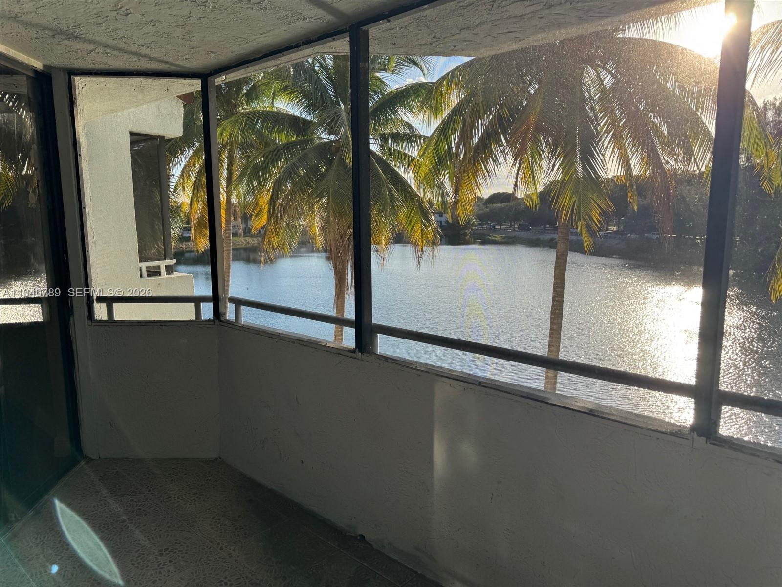 8335 Southwest 152nd Avenue, Unit B309 Miami, FL 33193 - Photo 25 of 26 a view of a room with a floor to ceiling window and potted plants