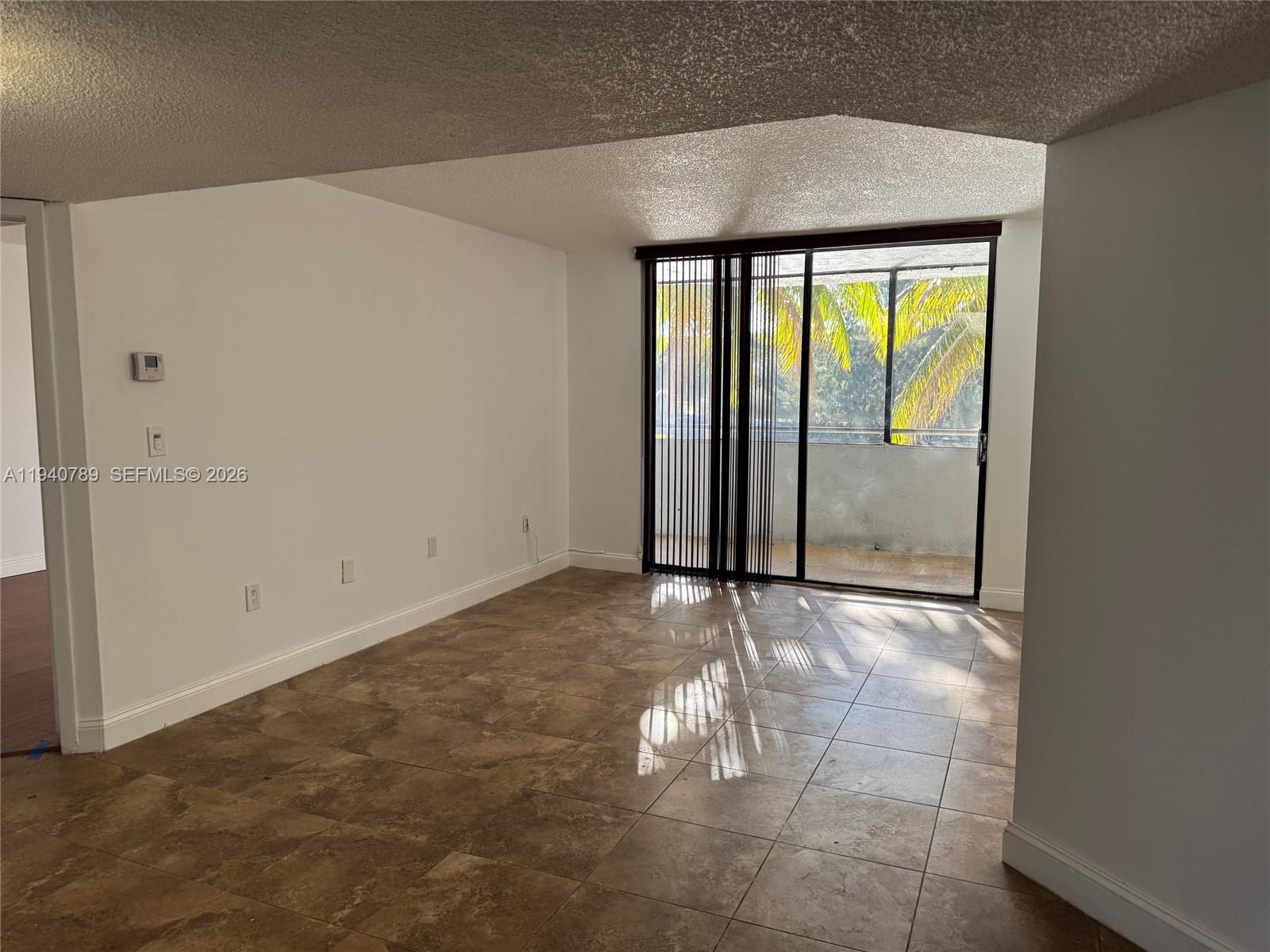 8335 Southwest 152nd Avenue, Unit B309 Miami, FL 33193 - Photo 6 of 26 a view of an empty room with a window