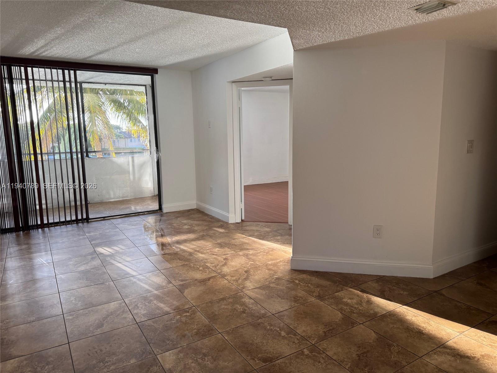 8335 Southwest 152nd Avenue, Unit B309 Miami, FL 33193 - Photo 9 of 26 an empty room with windows