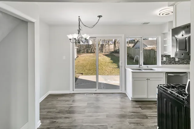 a view of a kitchen with a sink and cabinets