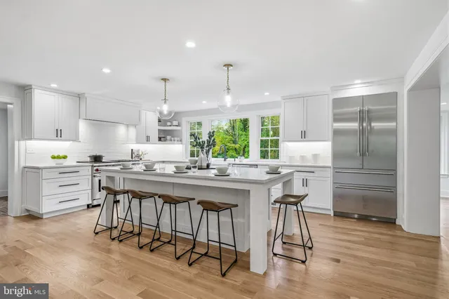 a stove top oven sitting inside of a kitchen