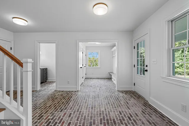 a bedroom with a large bed and a potted plant