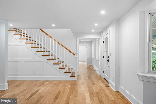 a spacious bathroom with a granite countertop sink a mirror and a shower