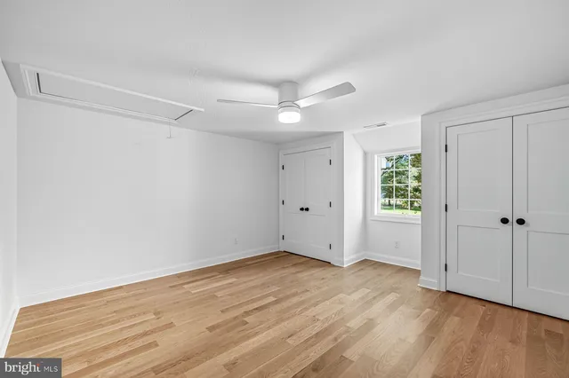 a bathroom with a granite countertop sink mirror and a toilet