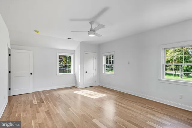 a view of empty room with wooden floor