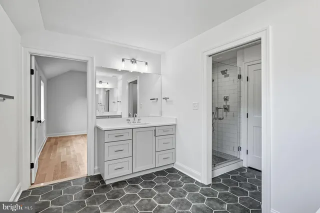 a bathroom with a sink mirror and vanity