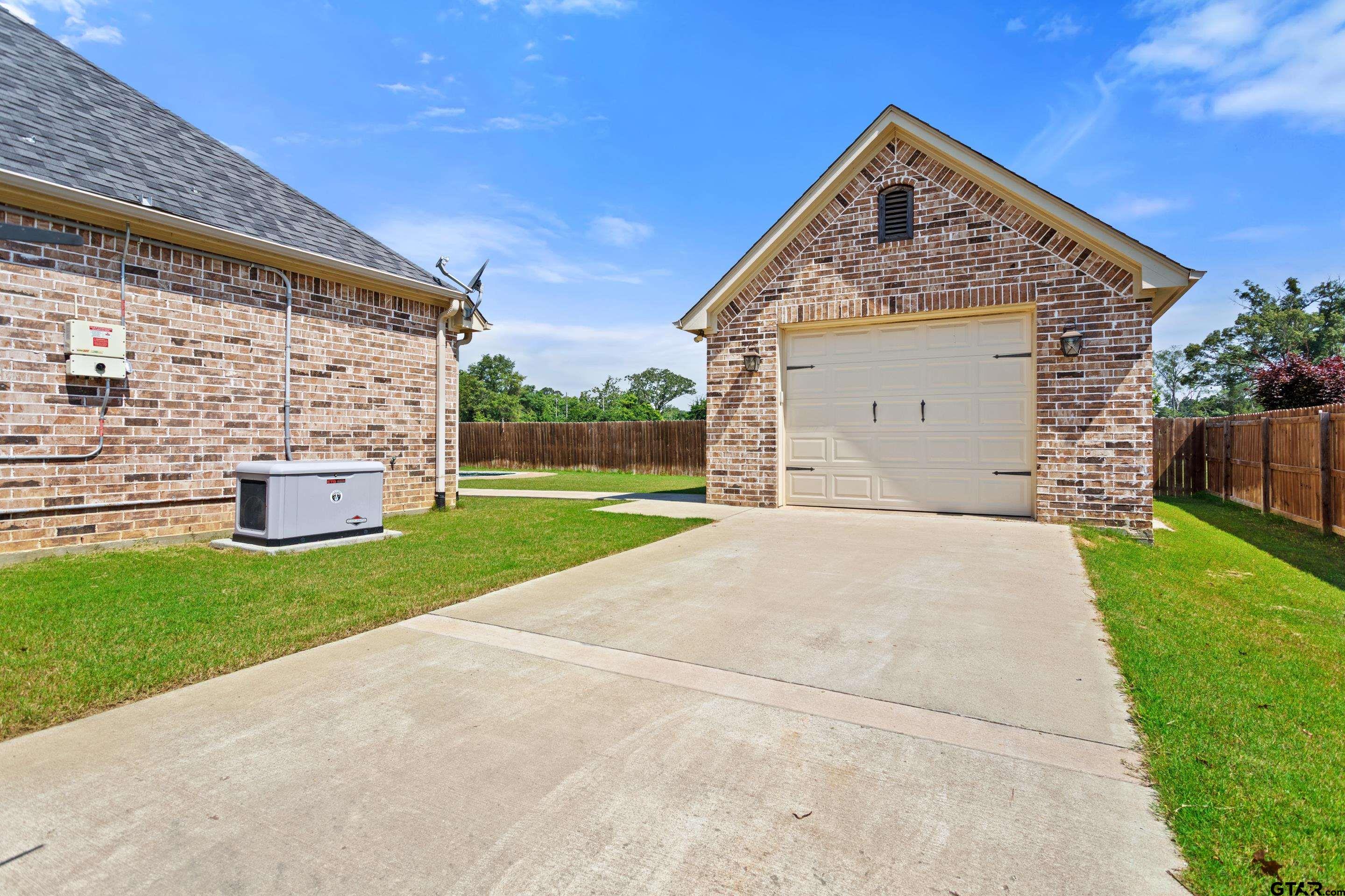 105 Nathan Road Chandler, TX 75758 - Photo 34 of 36 a front view of a house with a yard and garage