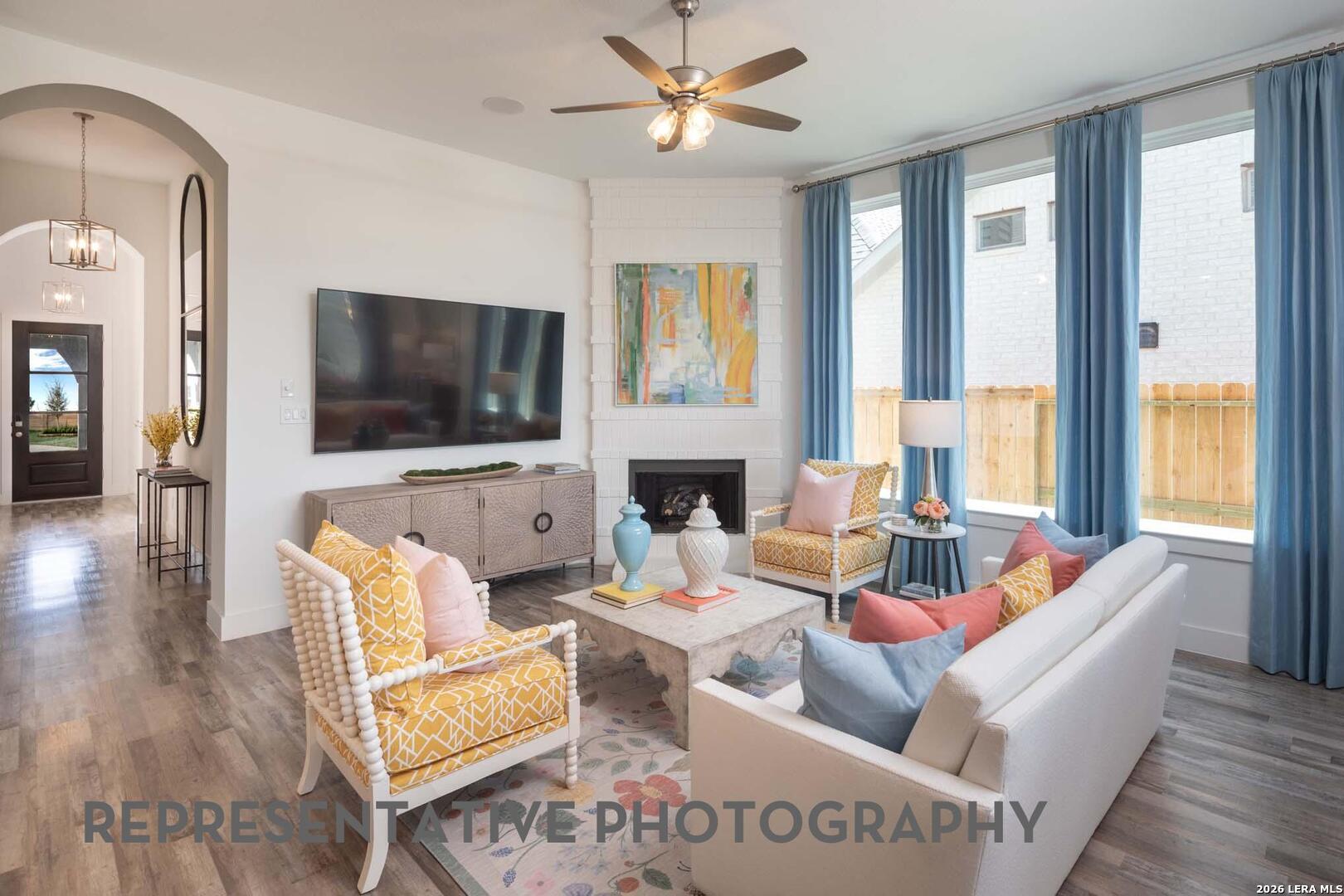 237 Boulder Creek Boerne, TX 78006 - Photo 11 of 32 a living room with fireplace furniture and a flat screen tv