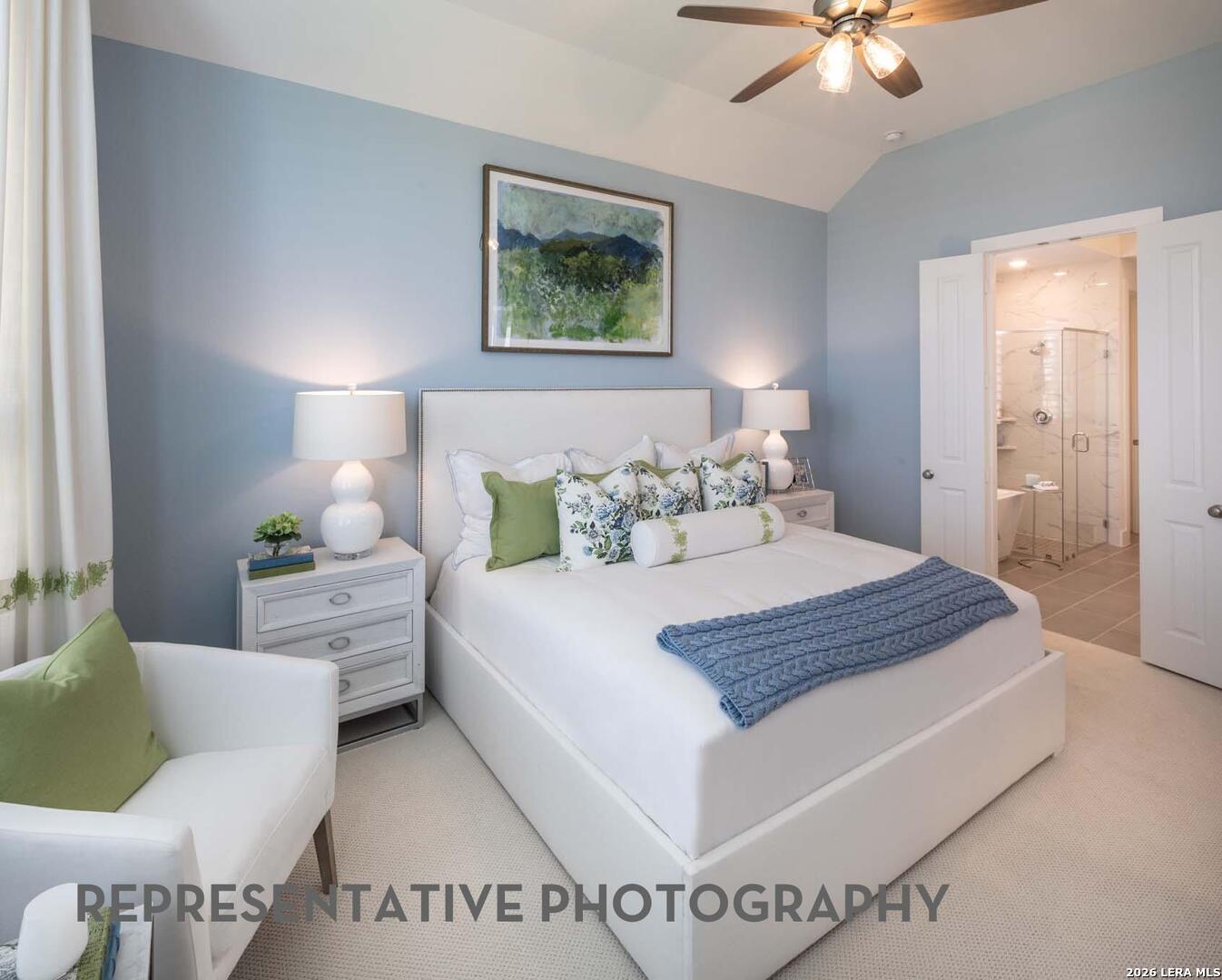 237 Boulder Creek Boerne, TX 78006 - Photo 13 of 32 a bedroom with a bed and a chandelier