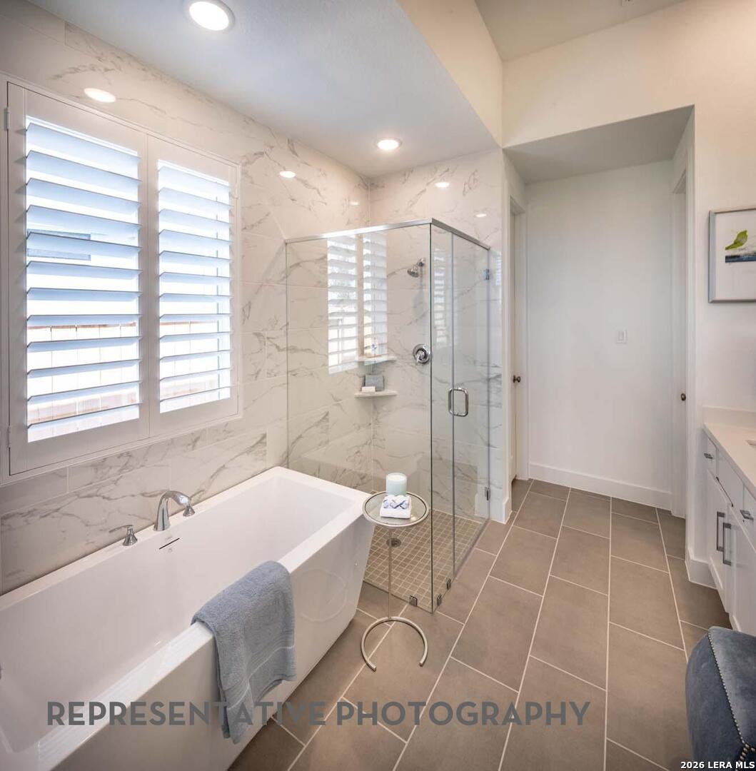 237 Boulder Creek Boerne, TX 78006 - Photo 17 of 32 a bath room with a bath tub and a shower