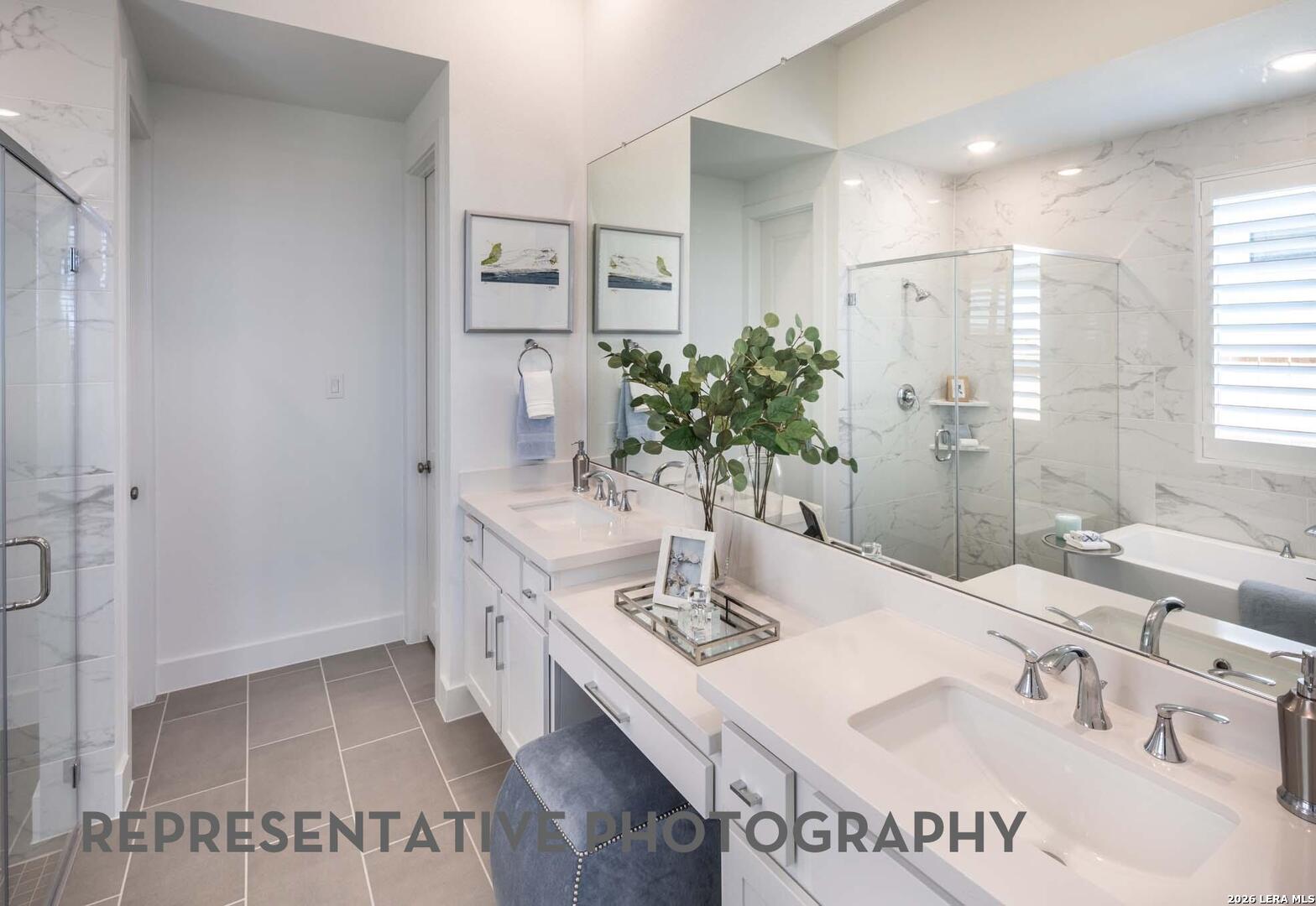 237 Boulder Creek Boerne, TX 78006 - Photo 20 of 32 a bathroom with a granite countertop sink a mirror and a shower