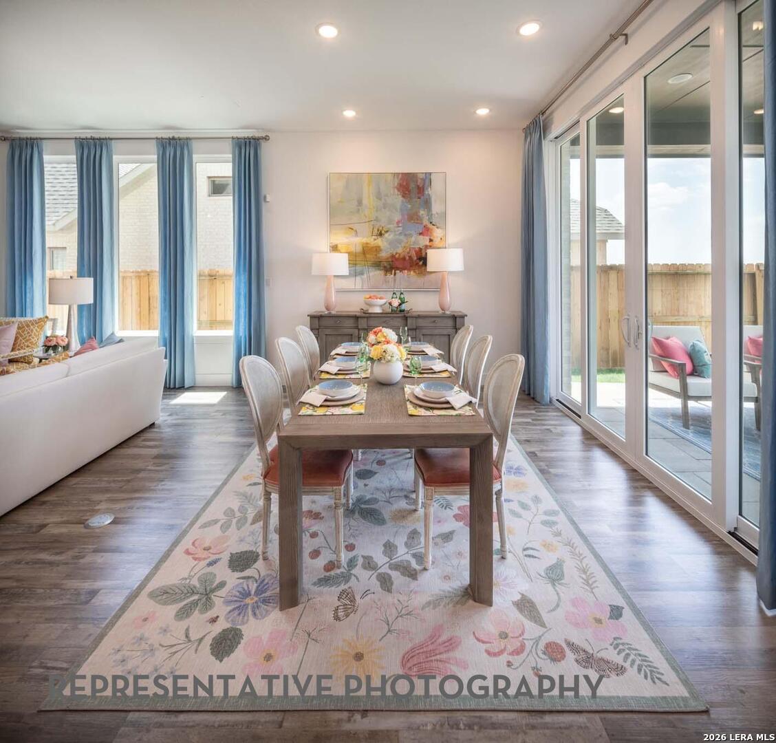 237 Boulder Creek Boerne, TX 78006 - Photo 25 of 32 a living room with furniture a large window and wooden floor