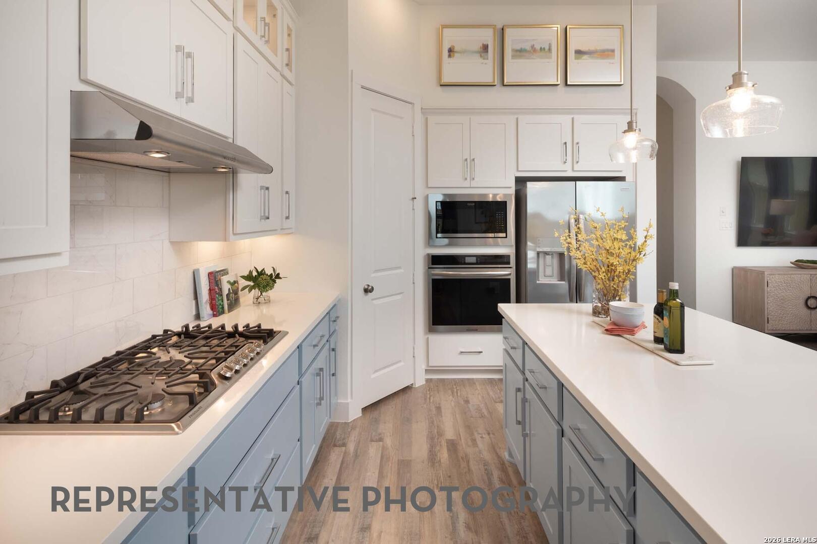 237 Boulder Creek Boerne, TX 78006 - Photo 7 of 32 a kitchen with a sink stove and refrigerator