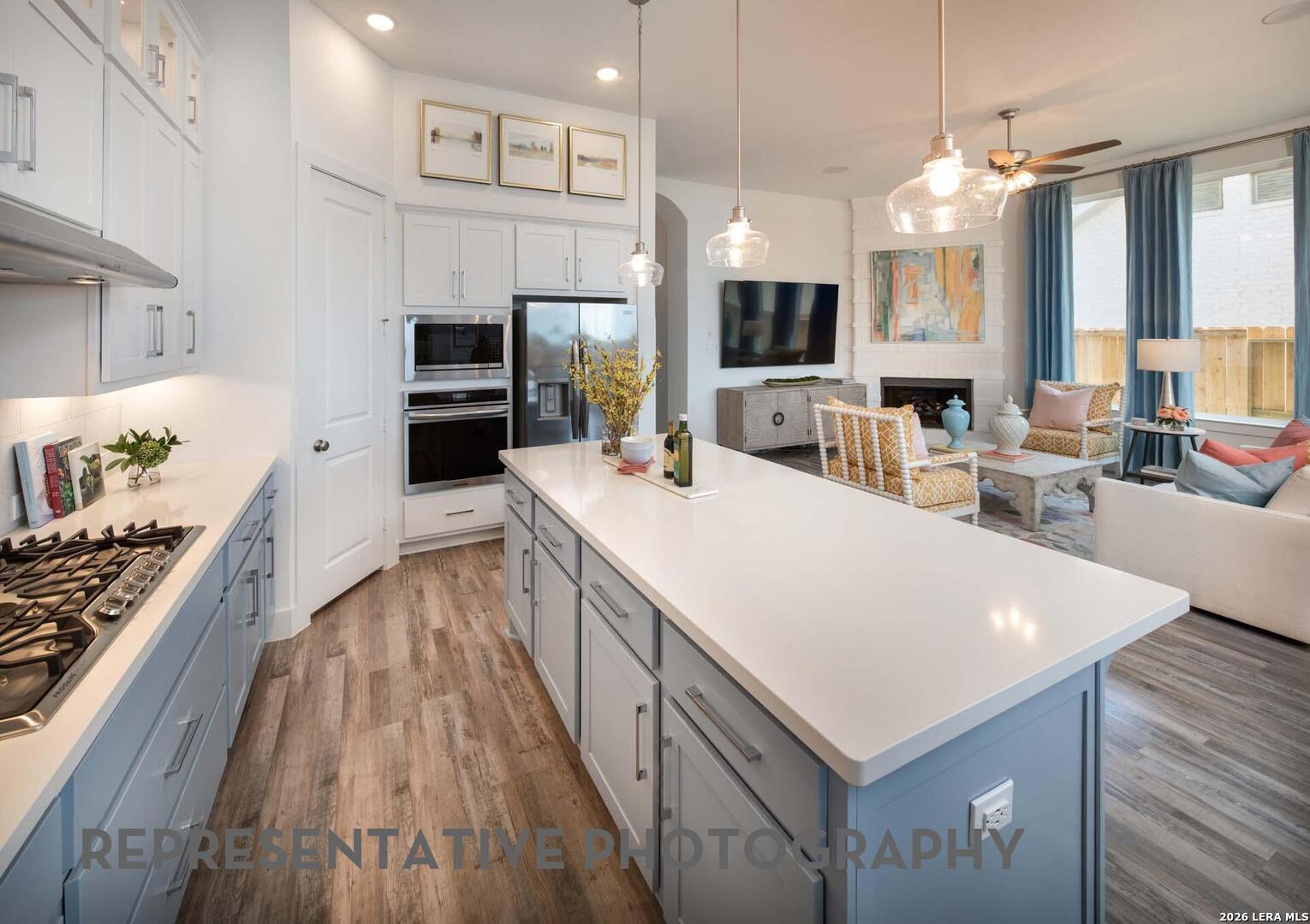 237 Boulder Creek Boerne, TX 78006 - Photo 8 of 32 a large kitchen with sink a microwave a stove and refrigerator