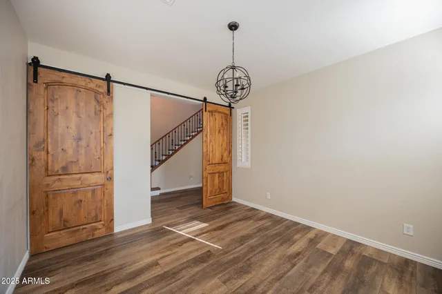 a view of a hallway with wooden floor and entryway