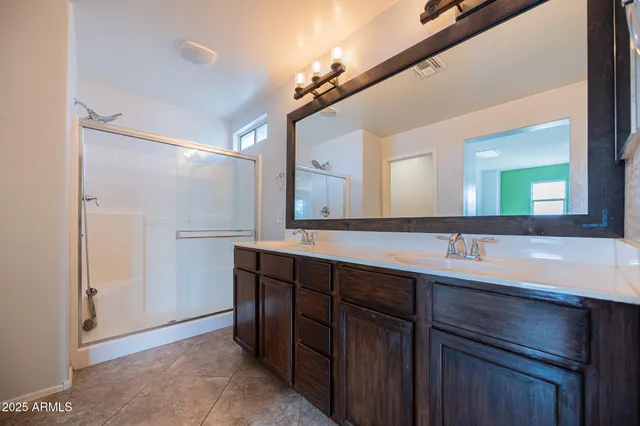 a bathroom with a double vanity sink and a mirror