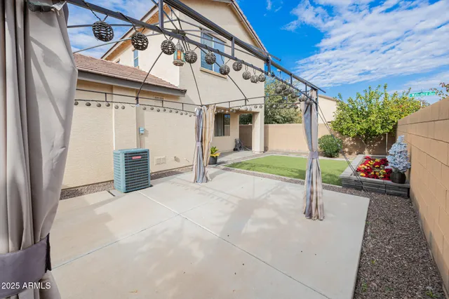 a view of a house with backyard and porch