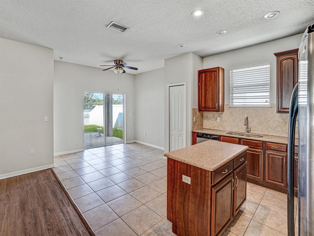 11713 Colony Lakes Boulevard New Port Richey, FL 34654 - Photo 13 of 38 a kitchen with stainless steel appliances granite countertop a stove a sink and a refrigerator