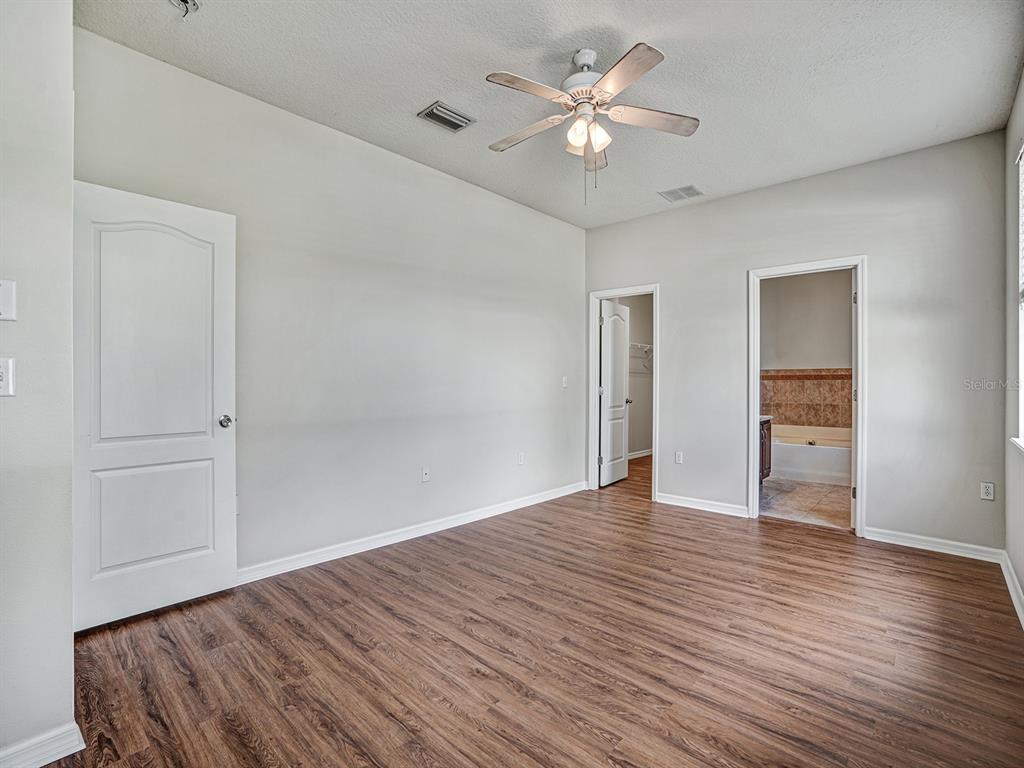 11713 Colony Lakes Boulevard New Port Richey, FL 34654 - Photo 15 of 38 a view of an empty room with wooden floor