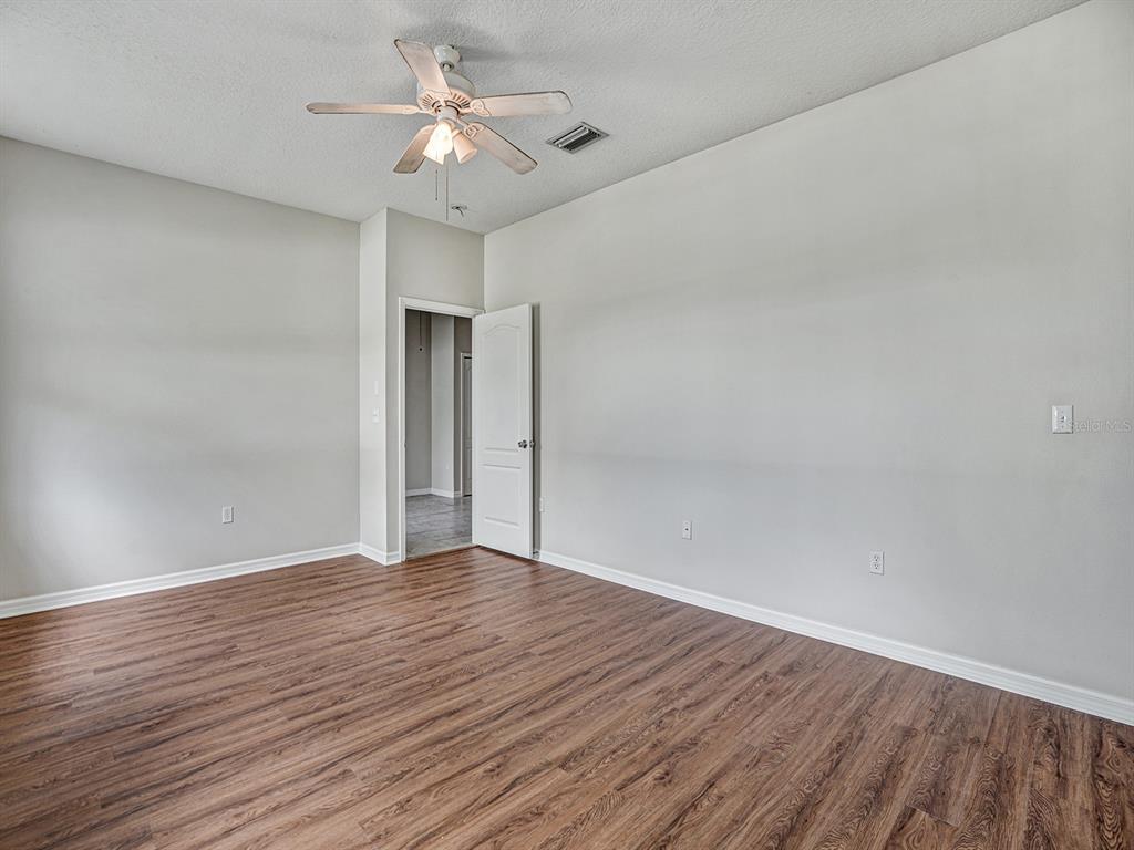 11713 Colony Lakes Boulevard New Port Richey, FL 34654 - Photo 16 of 38 a view of an empty room with wooden floor