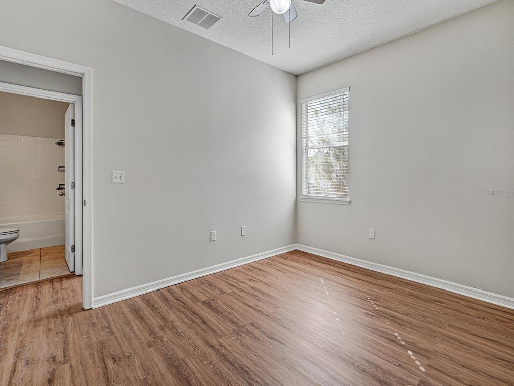 11713 Colony Lakes Boulevard New Port Richey, FL 34654 - Photo 26 of 38 wooden floor in an empty room with a window