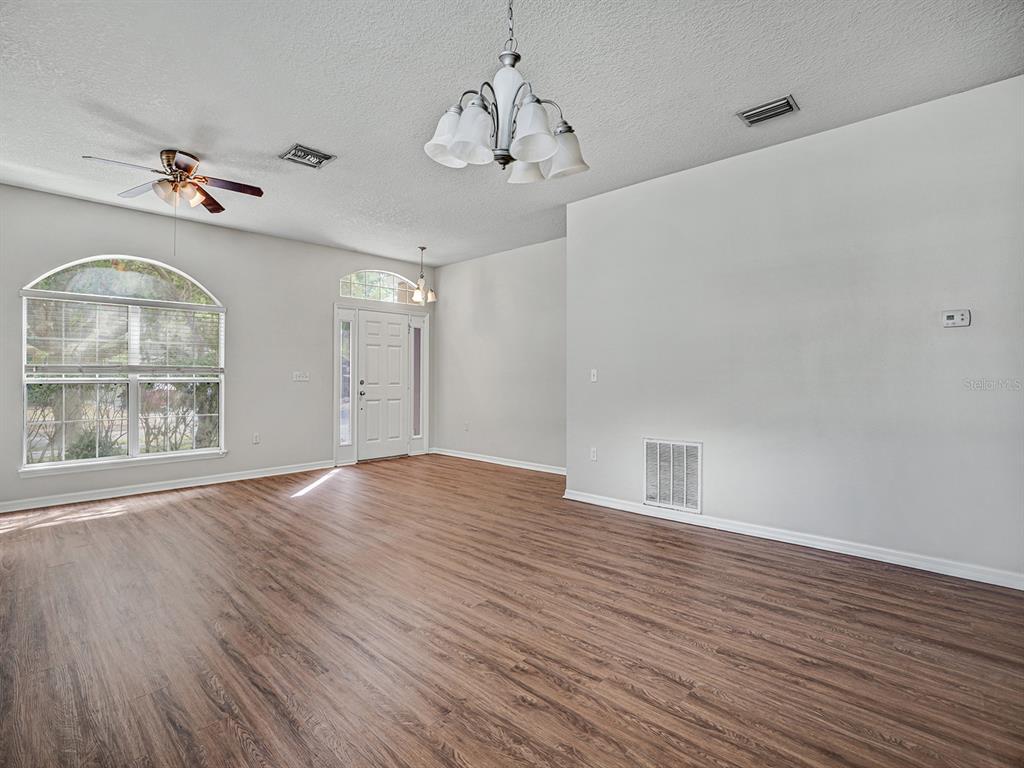 11713 Colony Lakes Boulevard New Port Richey, FL 34654 - Photo 6 of 38 a view of an empty room with wooden floor and a window