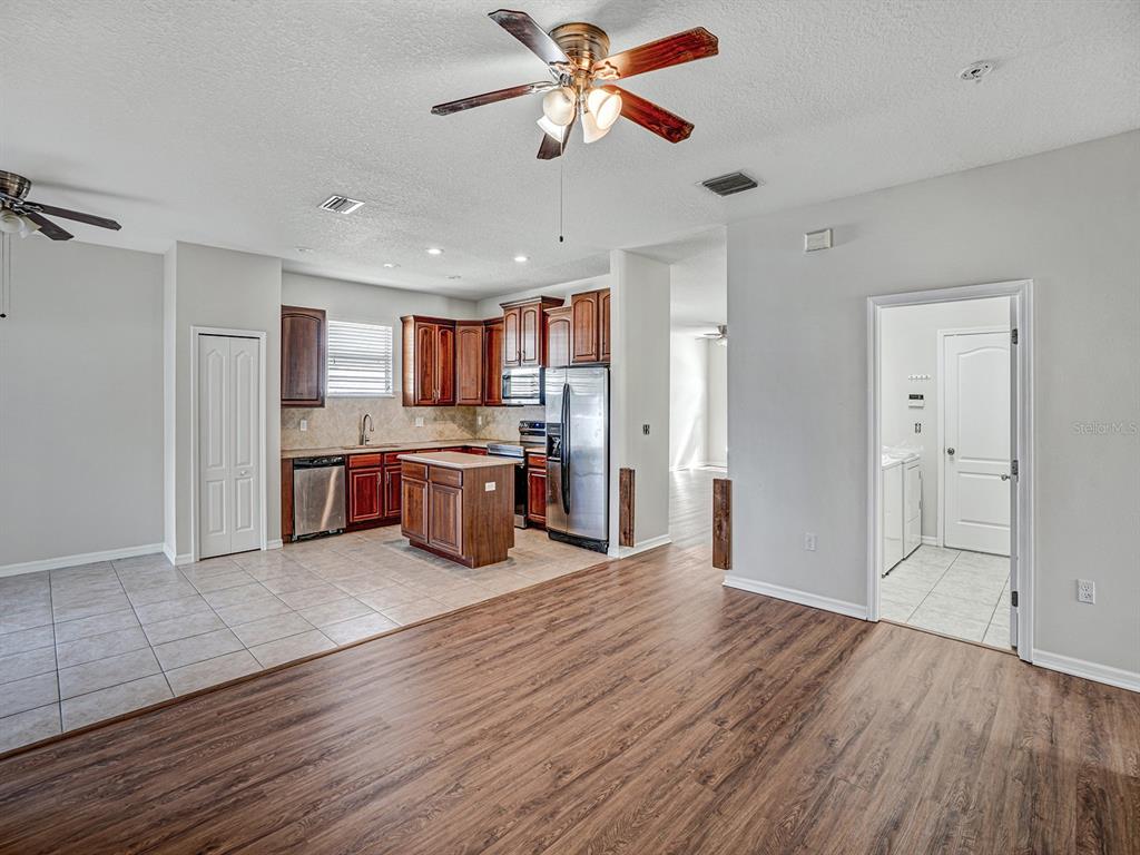 11713 Colony Lakes Boulevard New Port Richey, FL 34654 - Photo 9 of 38 a kitchen with stainless steel appliances granite countertop a refrigerator and a stove top oven