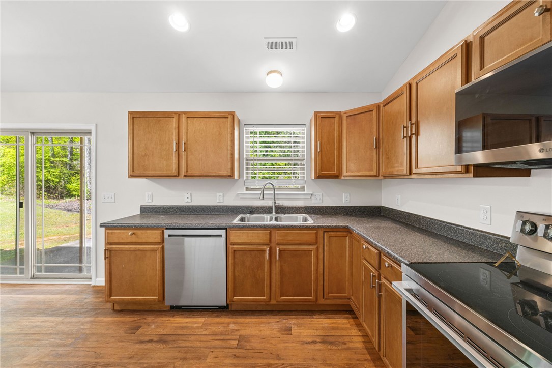 113 Crofton Court Easley, SC 29642 - Photo 13 of 33 This bright kitchen features ample cabinetry and a glass door leading to the outdoors.