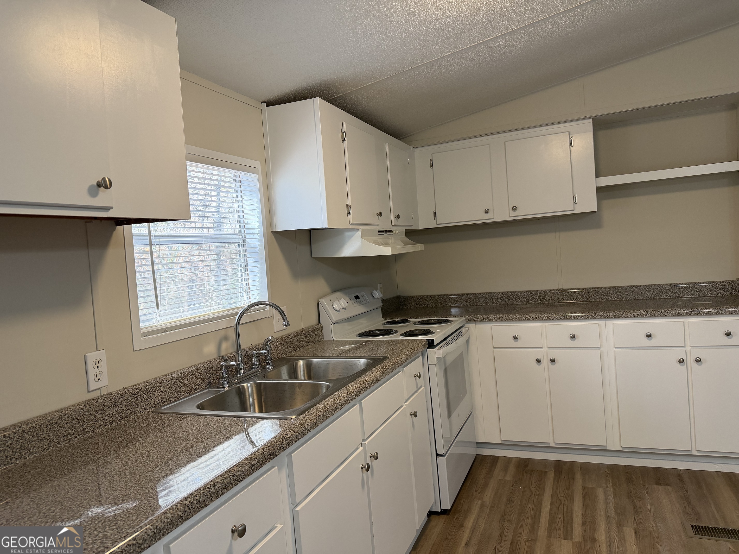 927 Louis Road Rentz, GA 31075 - Photo 11 of 22 a kitchen with granite countertop white cabinets and a sink