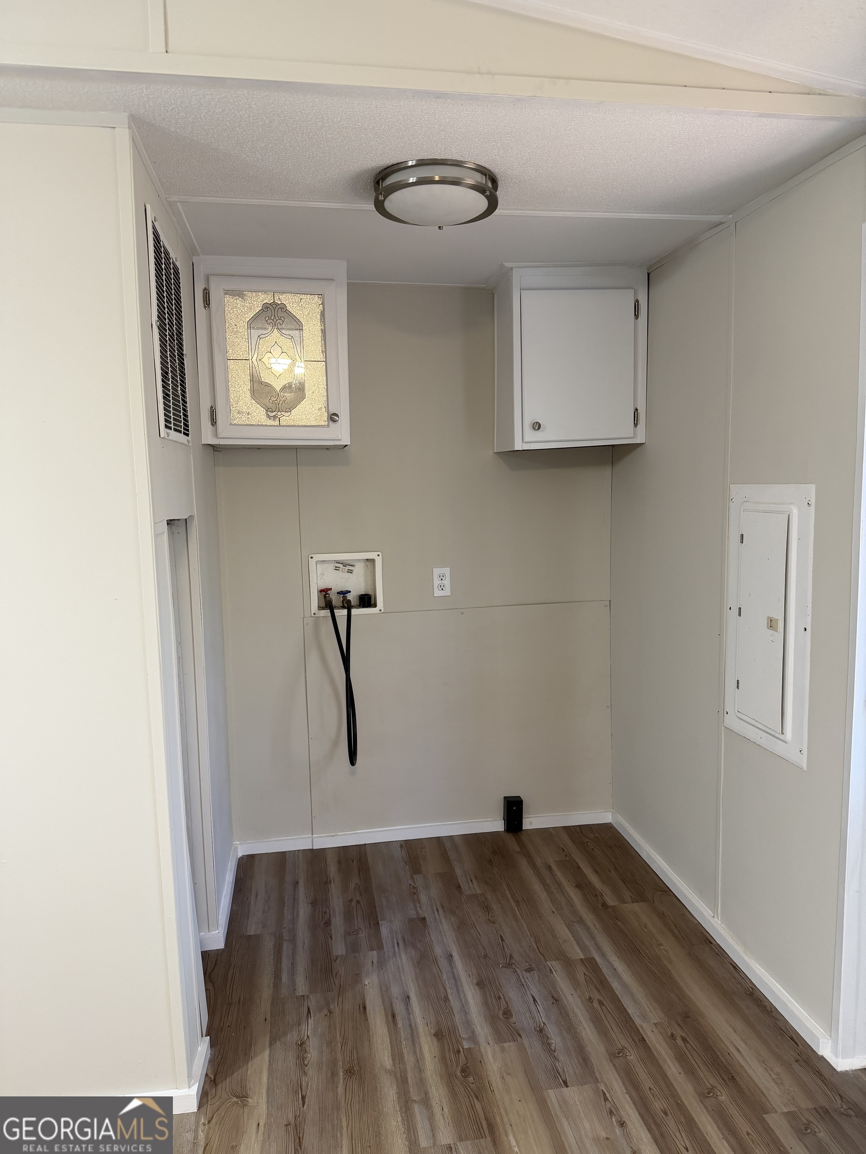 927 Louis Road Rentz, GA 31075 - Photo 12 of 22 a view of empty room with wooden floor and window