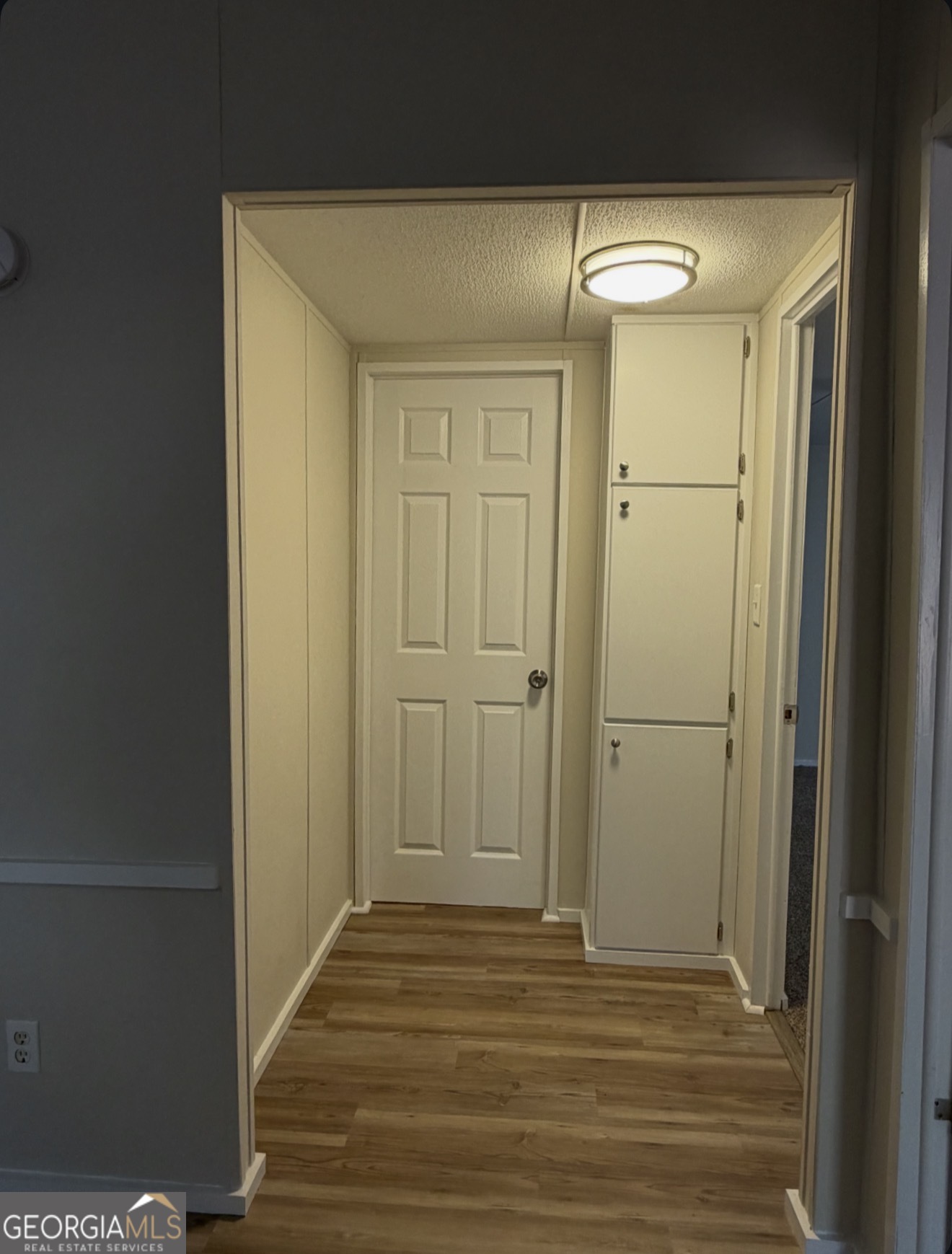 927 Louis Road Rentz, GA 31075 - Photo 19 of 22 a view of a hallway with wooden floor