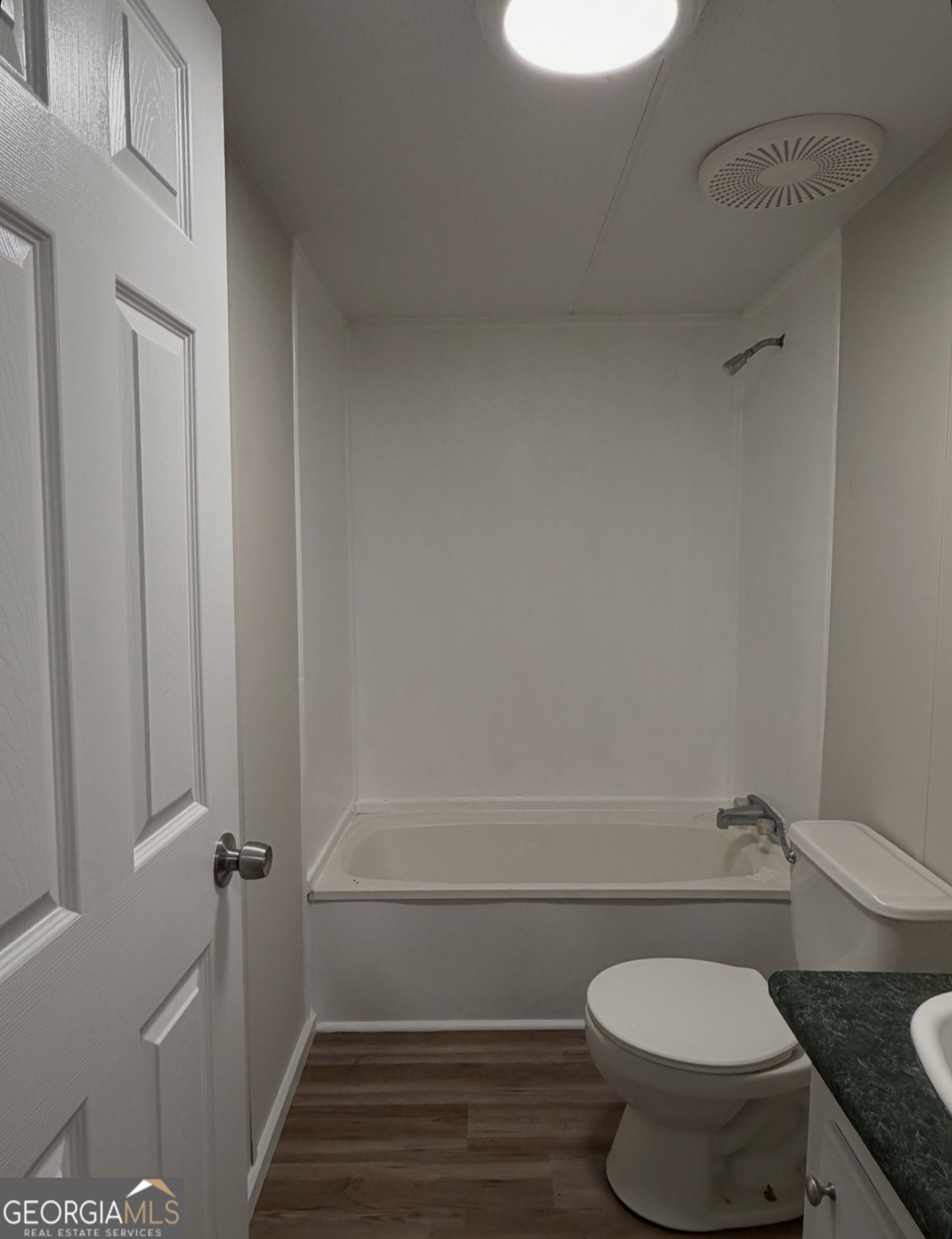 927 Louis Road Rentz, GA 31075 - Photo 20 of 22 a bathroom with a granite countertop toilet and a sink