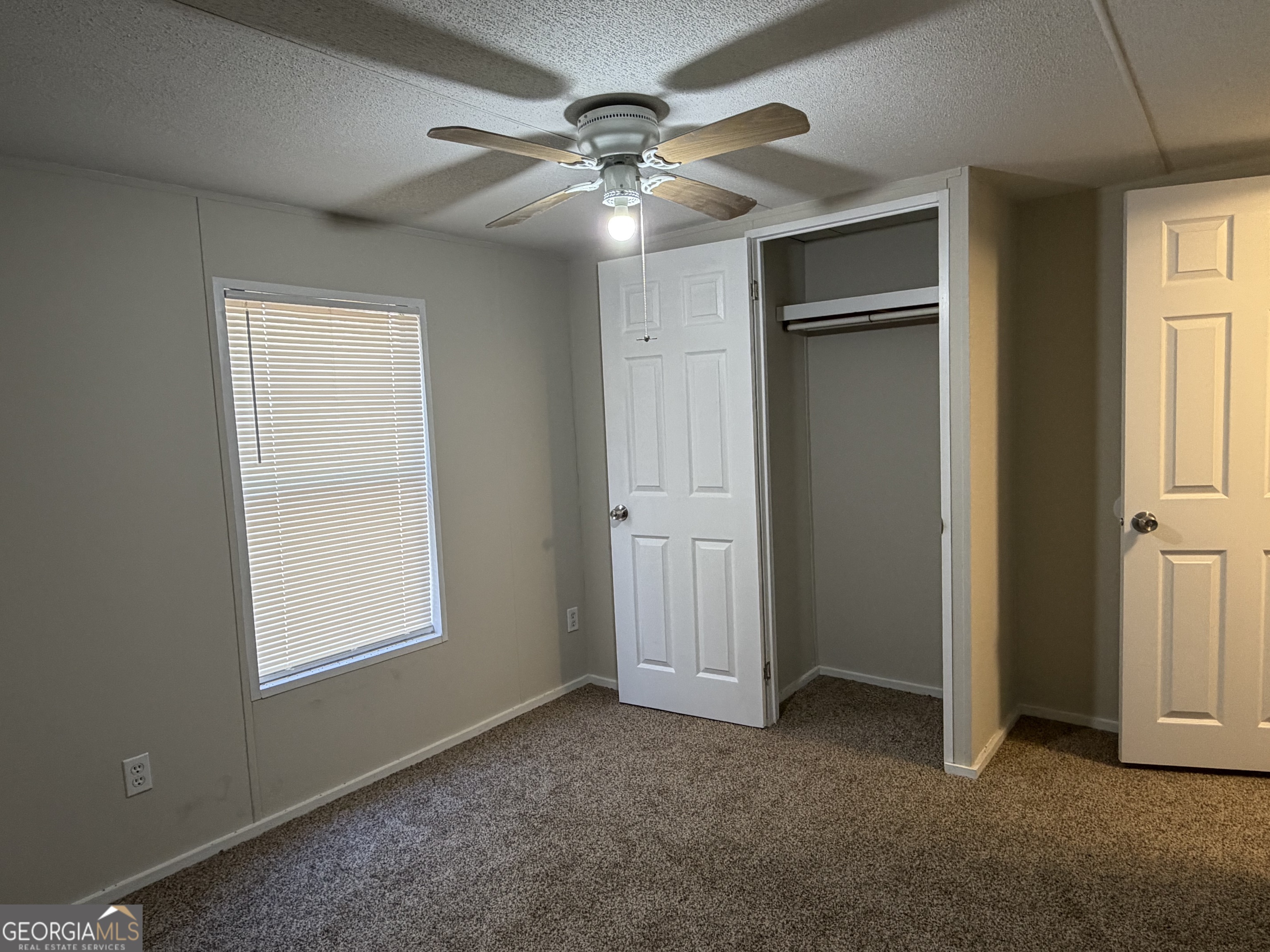 927 Louis Road Rentz, GA 31075 - Photo 21 of 22 an empty room with windows and closet
