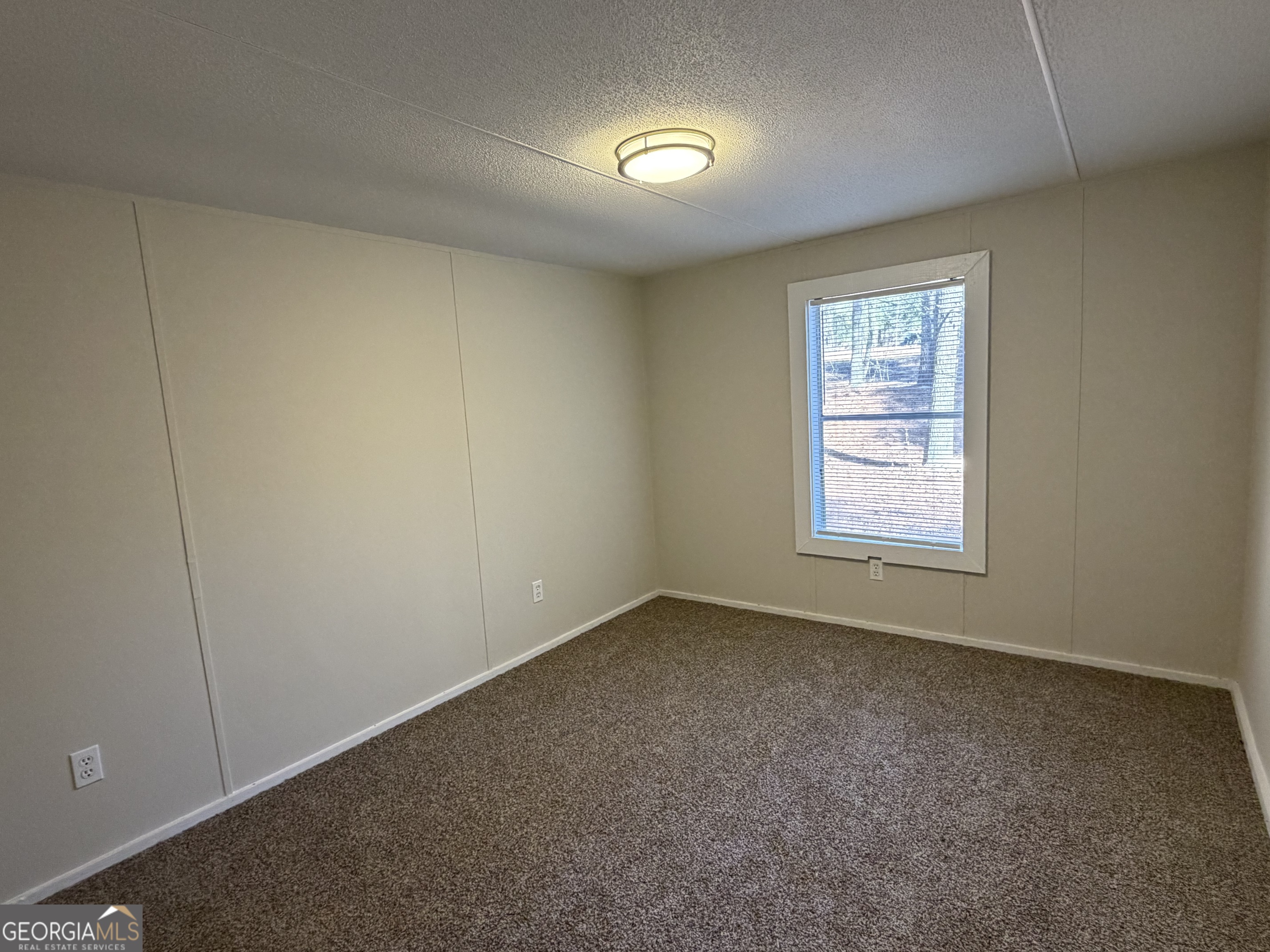 927 Louis Road Rentz, GA 31075 - Photo 22 of 22 an empty room with windows