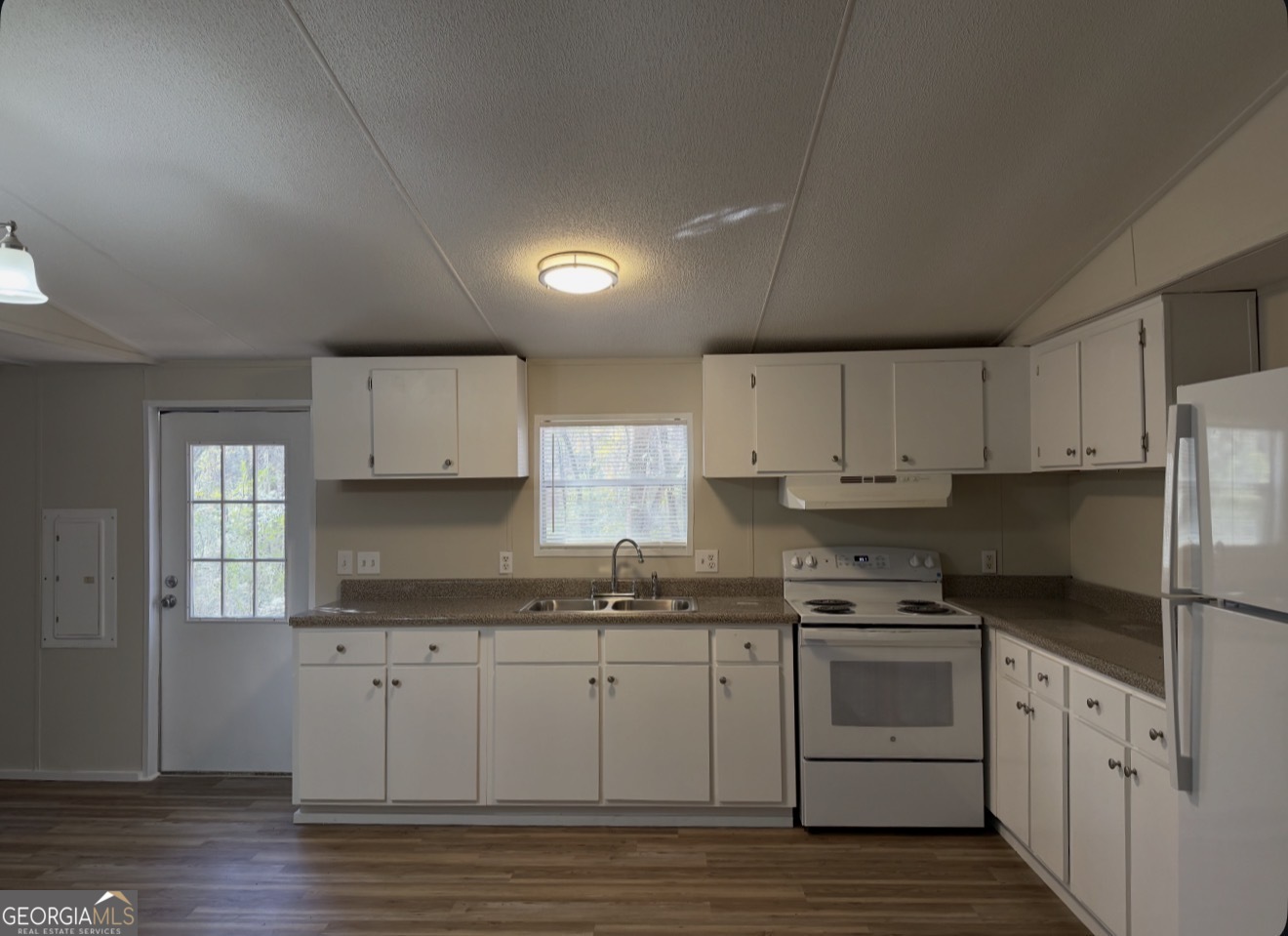 927 Louis Road Rentz, GA 31075 - Photo 10 of 22 a kitchen with granite countertop white cabinets and white appliances