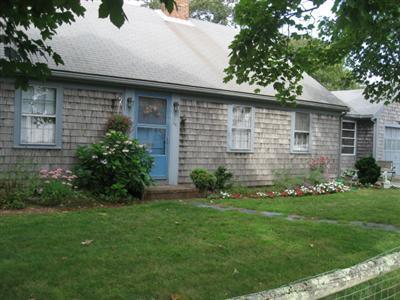 46 Pilgrim Road Harwich Port, MA 02646 - Photo 1 of 17 a front view of a house with a garden