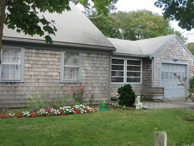 46 Pilgrim Road Harwich Port, MA 02646 - Photo 2 of 17 a front view of a house with a garden