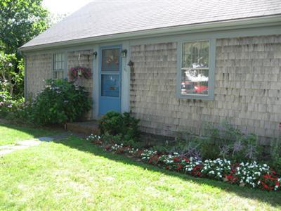 46 Pilgrim Road Harwich Port, MA 02646 - Photo 3 of 17 a front view of a house with a yard