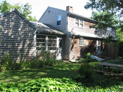 46 Pilgrim Road Harwich Port, MA 02646 - Photo 4 of 17 a front view of a house with a garden and plants